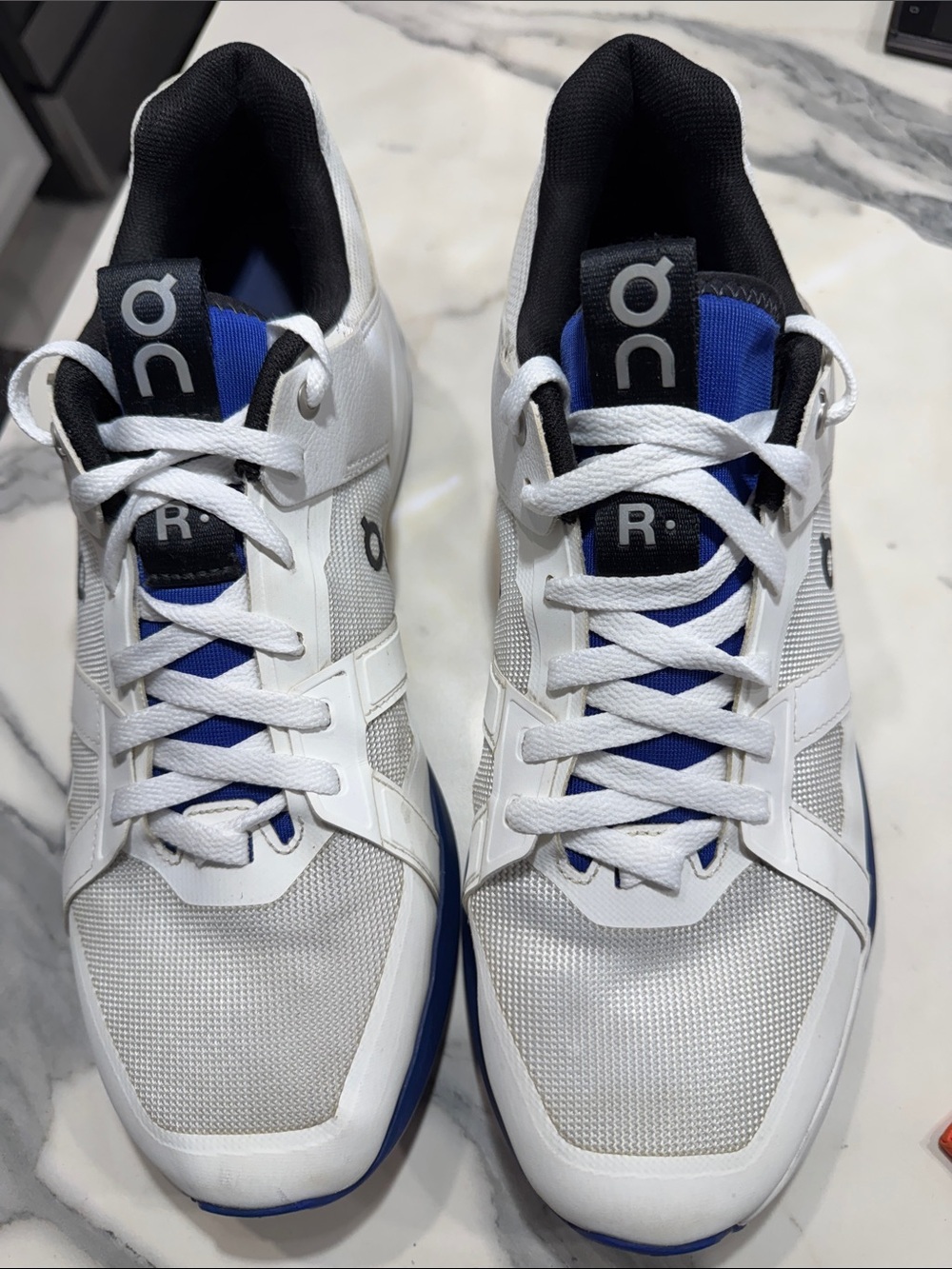 On Running White and Blue Men's Athletic Sneakers on the Roger